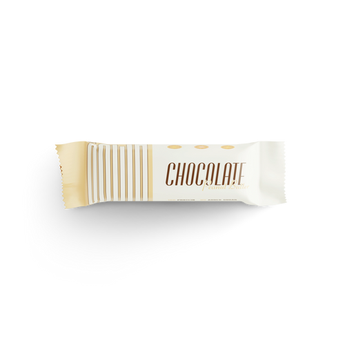 Chocolate peanut butter protein bar in cream and gold packaging on black background